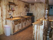 Custom Refinished Basement With Log Bar, Bar Stools And Wood Work 1 small